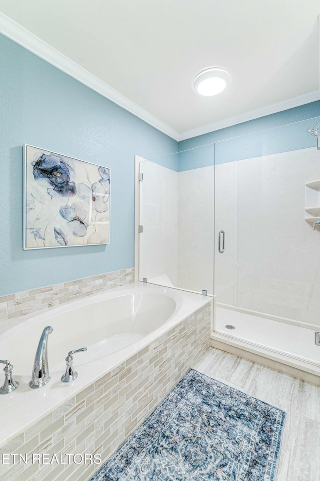 full bath featuring a stall shower, ornamental molding, and a bath