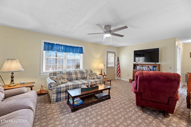 living room with ceiling fan, carpet, and a textured ceiling