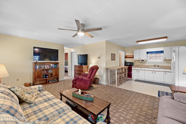 living room featuring sink and ceiling fan