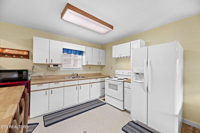 kitchen with white cabinetry, sink, and white appliances