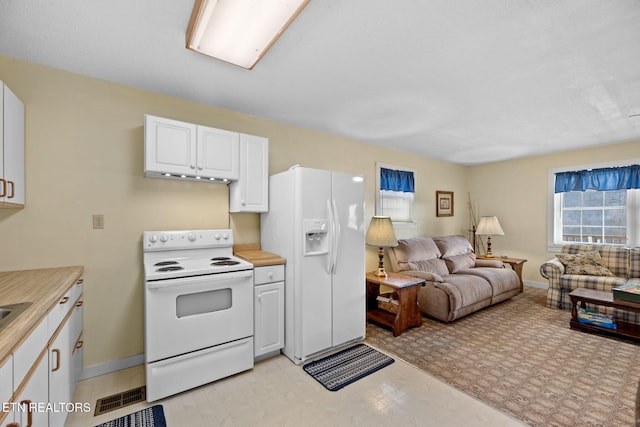 kitchen featuring white appliances and white cabinets