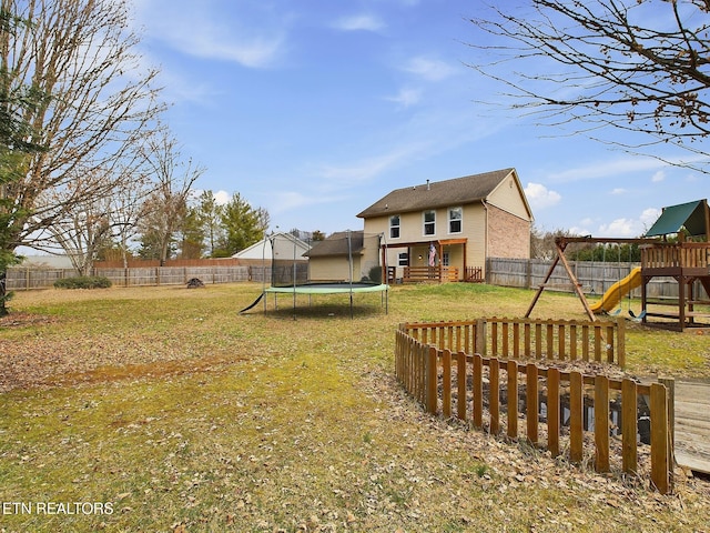 view of yard featuring a playground and a trampoline