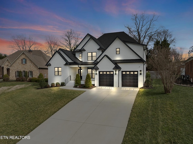 modern farmhouse with driveway, an attached garage, and a front yard