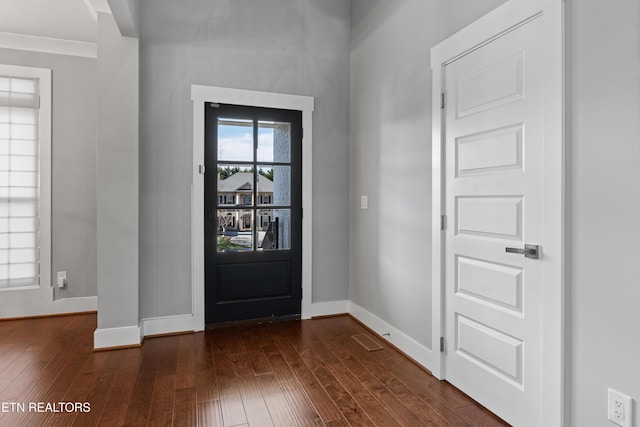 entrance foyer featuring baseboards and dark wood-type flooring