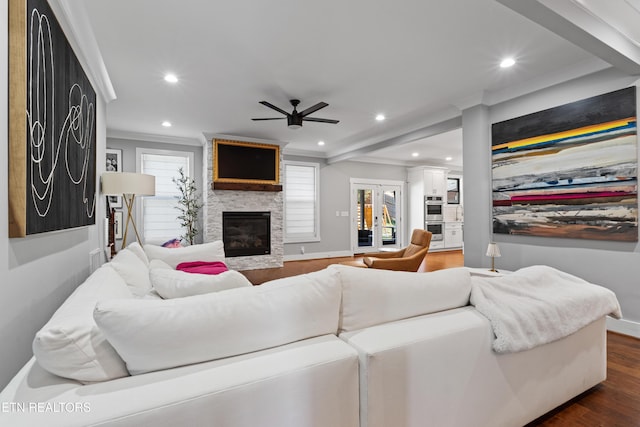 living room with recessed lighting, a fireplace, baseboards, dark wood-style floors, and crown molding