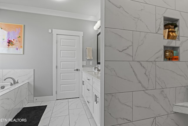 full bathroom featuring marble finish floor, ornamental molding, a garden tub, and vanity