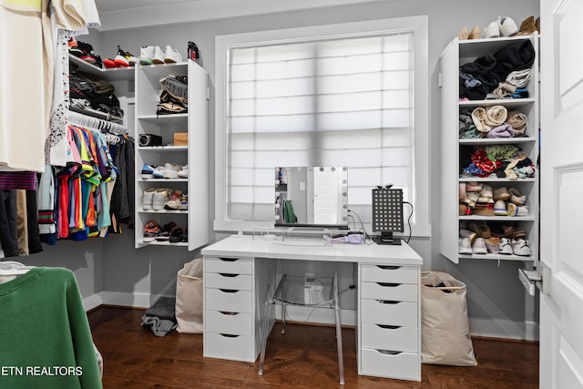 walk in closet featuring dark wood finished floors