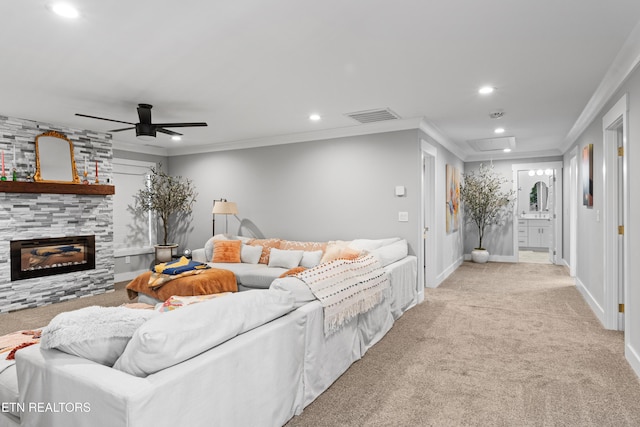 carpeted living area with attic access, visible vents, crown molding, a fireplace, and recessed lighting