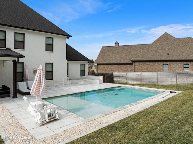 view of pool with a fenced in pool, a yard, a fenced backyard, and a patio