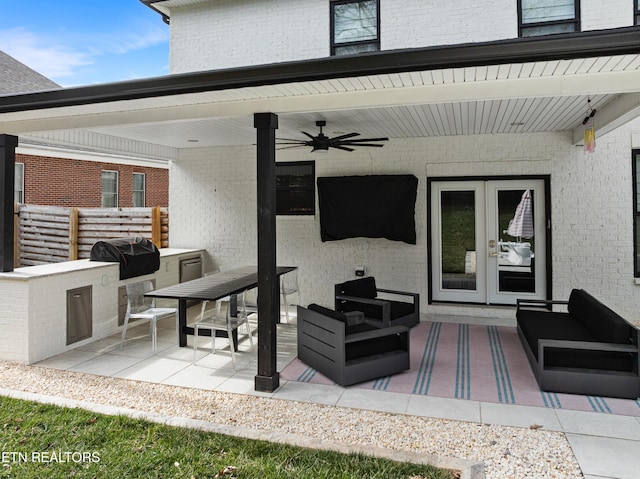 view of patio with area for grilling, ceiling fan, outdoor lounge area, and fence