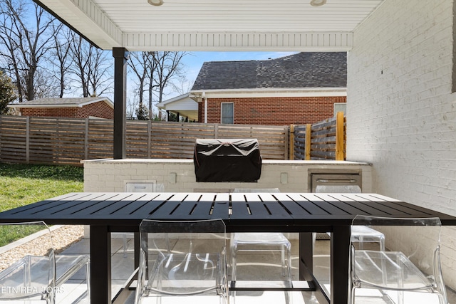 view of patio / terrace with outdoor dining space, fence, and area for grilling