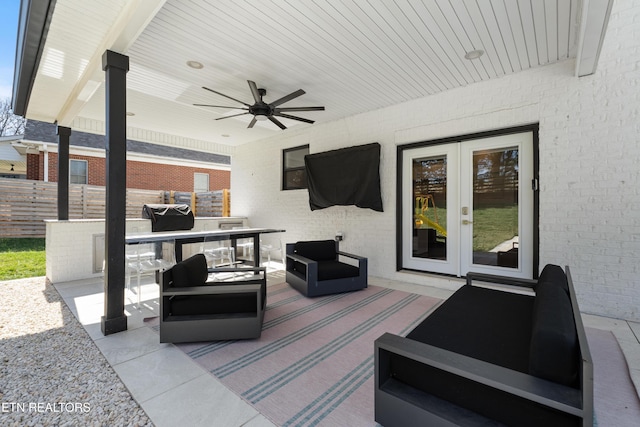 view of patio with ceiling fan, fence, outdoor lounge area, and french doors