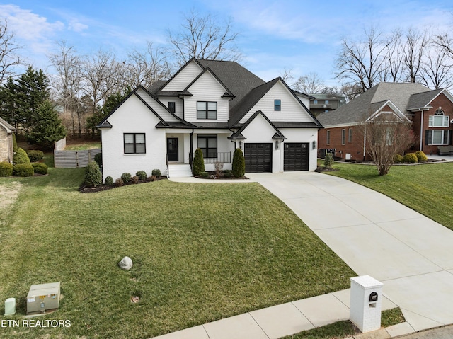 modern farmhouse style home with driveway, roof with shingles, an attached garage, fence, and a front lawn