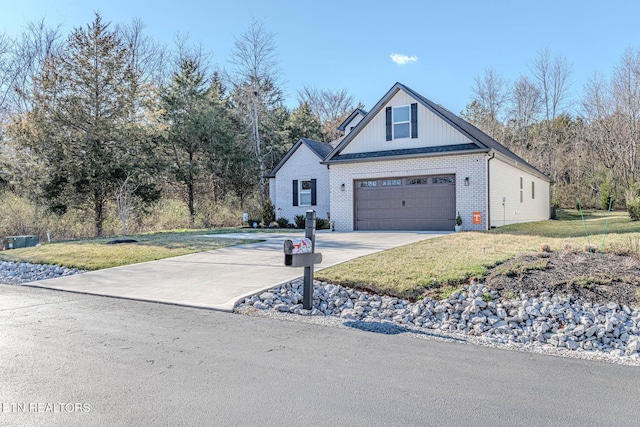 view of front of house featuring a garage, concrete driveway, brick siding, and a front lawn