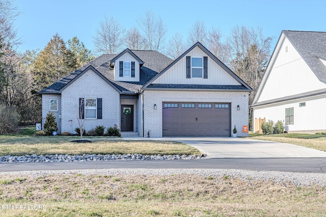 view of front of home featuring an attached garage, brick siding, driveway, roof with shingles, and a front yard