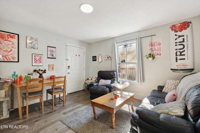 living room with baseboards and wood finished floors