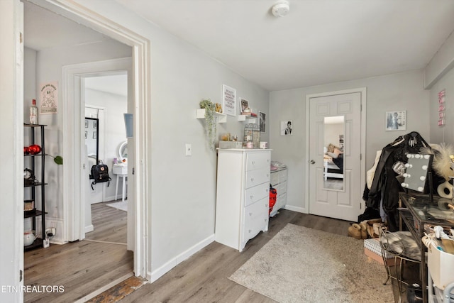 entryway featuring baseboards and wood finished floors