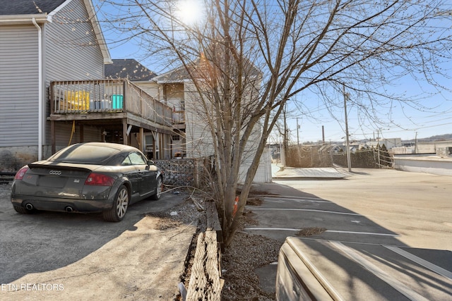 view of home's exterior with uncovered parking