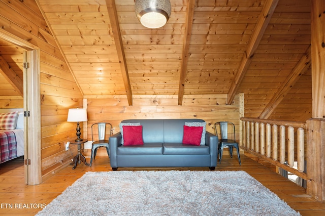 living room with hardwood / wood-style flooring, vaulted ceiling with beams, wooden ceiling, and wooden walls