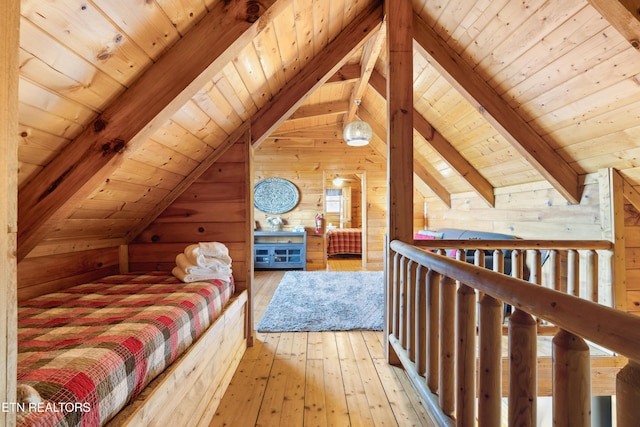 bedroom featuring lofted ceiling with beams, wood ceiling, wooden walls, and light hardwood / wood-style flooring