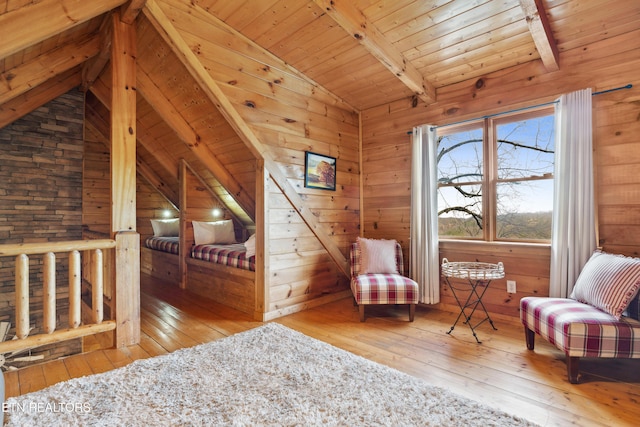 sitting room featuring wood ceiling, wooden walls, lofted ceiling with beams, and hardwood / wood-style flooring