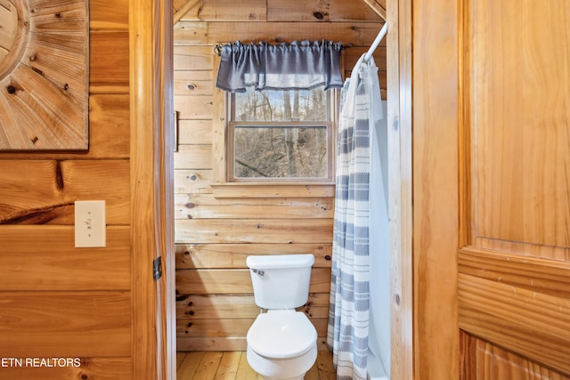 bathroom with toilet and hardwood / wood-style floors