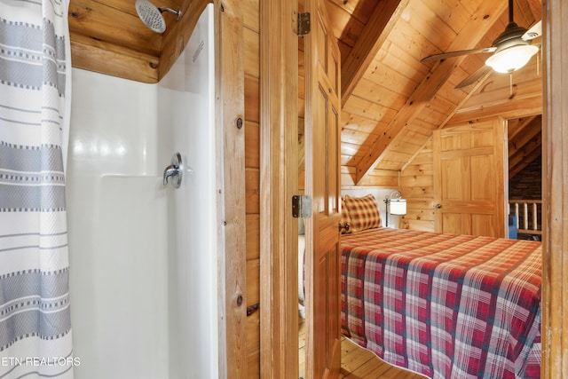 bedroom with vaulted ceiling with beams, wood ceiling, and wood walls