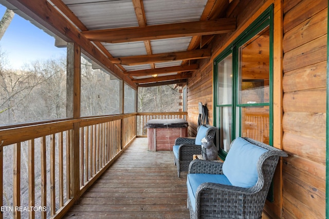 wooden deck featuring a hot tub