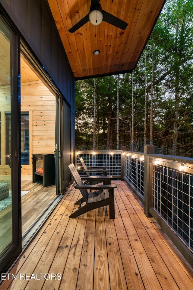 wooden terrace featuring ceiling fan
