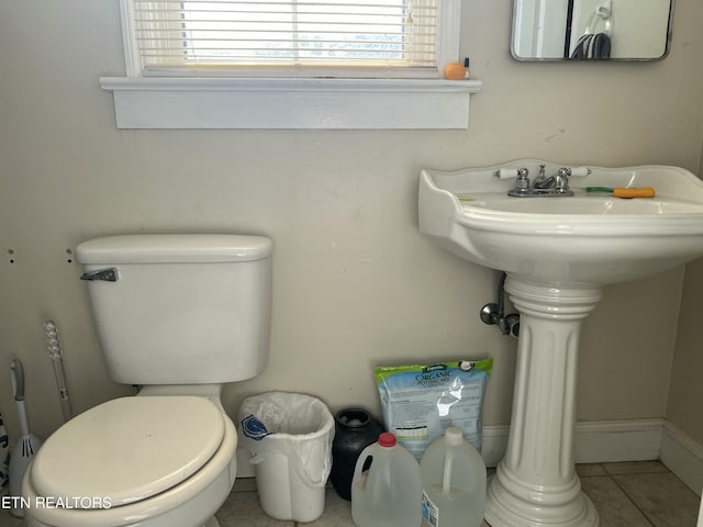 bathroom featuring a healthy amount of sunlight, toilet, and tile patterned flooring