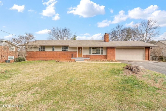 ranch-style house with a garage and a front yard