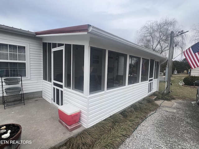 view of side of home with a sunroom