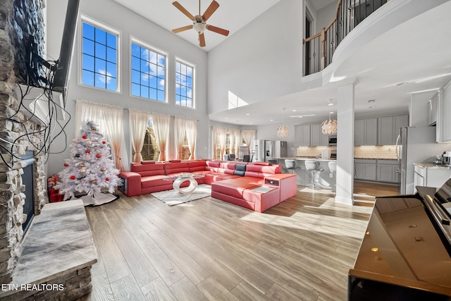 living room featuring ceiling fan and light hardwood / wood-style flooring