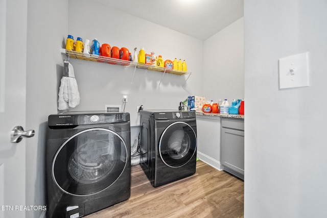 laundry area featuring washer and dryer and light wood-type flooring