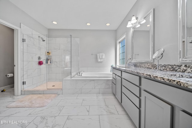 bathroom featuring vanity and shower with separate bathtub