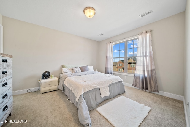 bedroom featuring light colored carpet