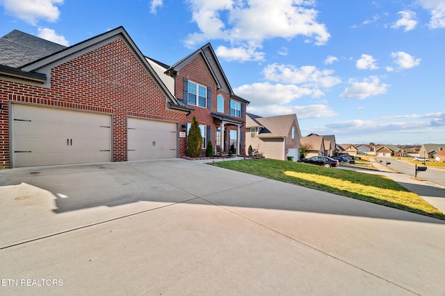 view of front of home featuring a garage and a front lawn