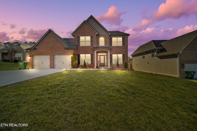 view of front of house featuring a garage and a yard