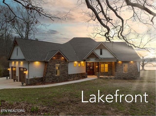 craftsman house with stone siding and roof with shingles