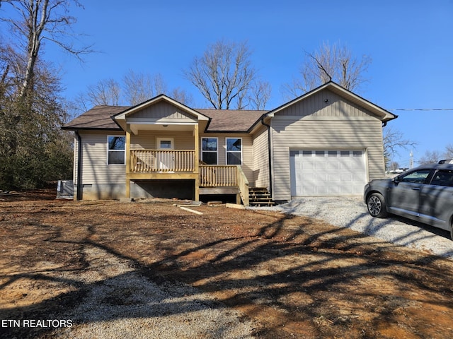 ranch-style house featuring a garage and covered porch