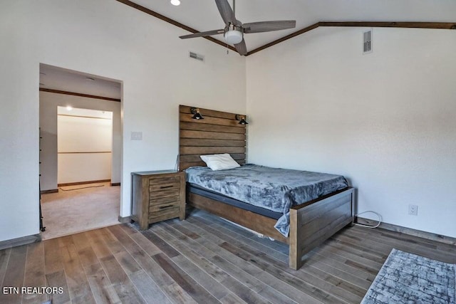 bedroom featuring crown molding, ceiling fan, dark hardwood / wood-style flooring, and high vaulted ceiling