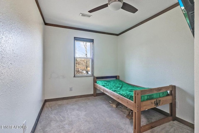 unfurnished bedroom with carpet floors, ornamental molding, and ceiling fan