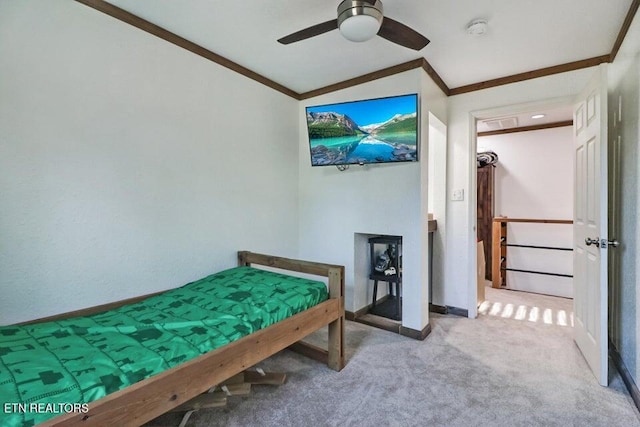 bedroom with crown molding, ceiling fan, and light carpet