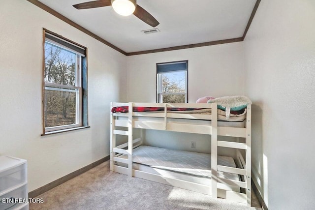 bedroom featuring crown molding, carpet, and ceiling fan