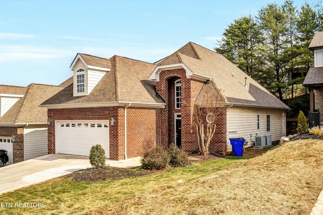 view of front facade with central AC, a garage, and a front lawn