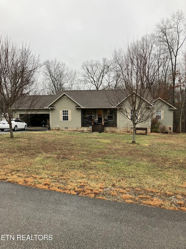 single story home featuring a porch, a garage, and a front lawn