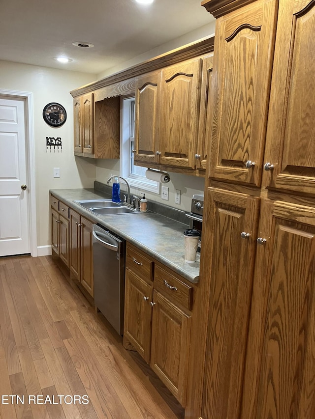 kitchen featuring sink, light hardwood / wood-style flooring, and stainless steel dishwasher