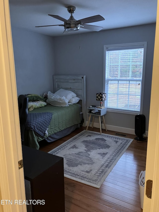 bedroom with dark wood-type flooring and ceiling fan