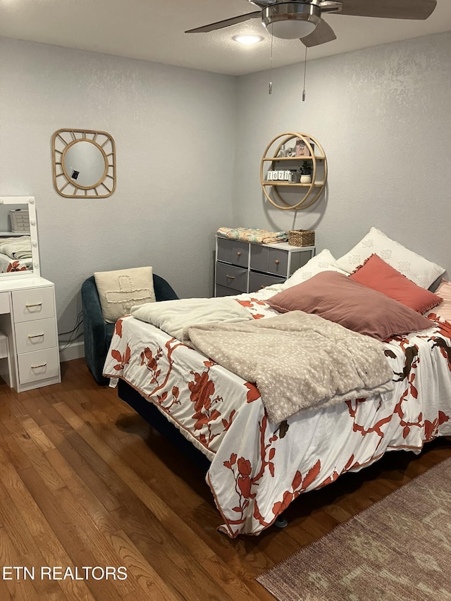 bedroom featuring dark wood-type flooring and ceiling fan