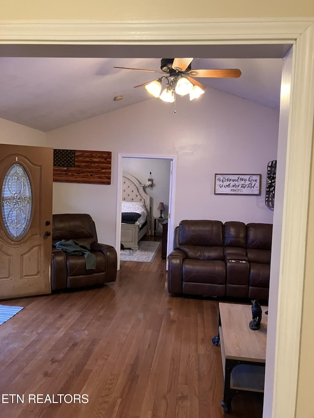 living room with vaulted ceiling, hardwood / wood-style floors, and ceiling fan